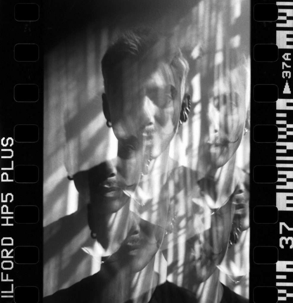 Intriguing black and white film multiple exposure portrait showcasing abstract creativity.
